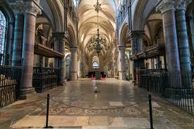 Interior of Canterbury Cathedral. A candle burns on the tiled floor to commemorate Becket's death.